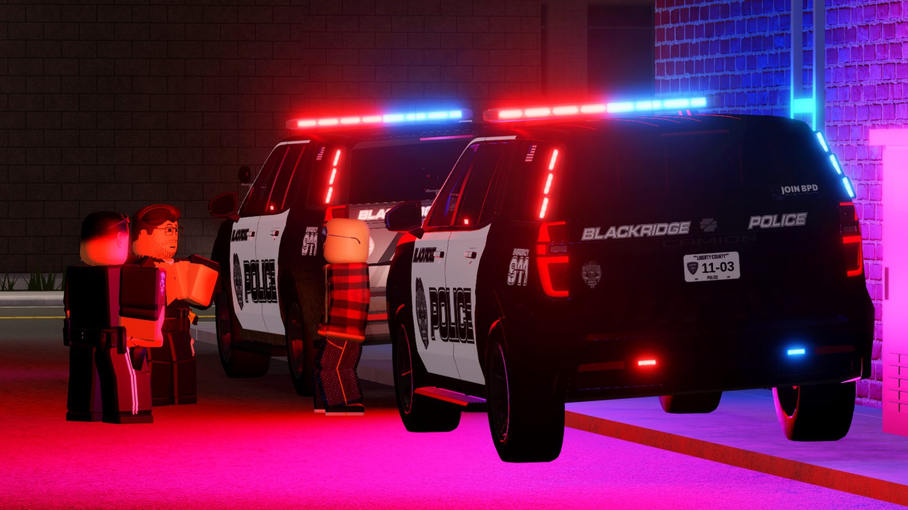 Blackridge police officers speak with a man beside patrol units overnight.